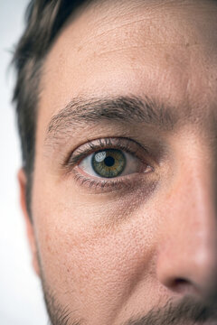 Close-up of a man's eye with green iris