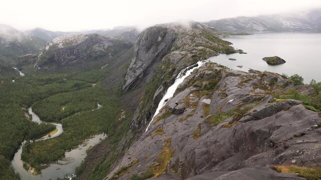Massive waterfall, V&aelig;rivassfossen, and lake in Rago National Park, Norway