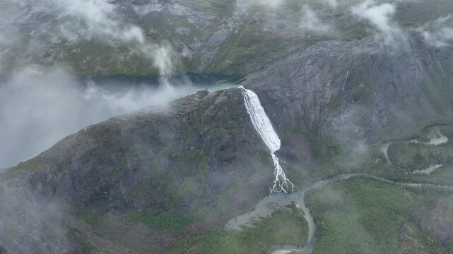 Aerial view of massive waterfall, V&aelig;rivassfossen, and lake in Rago National Park, Norway
