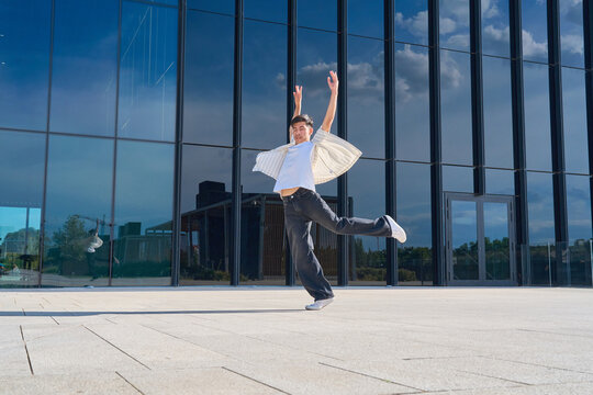 Young male dancer jumping in urban setting