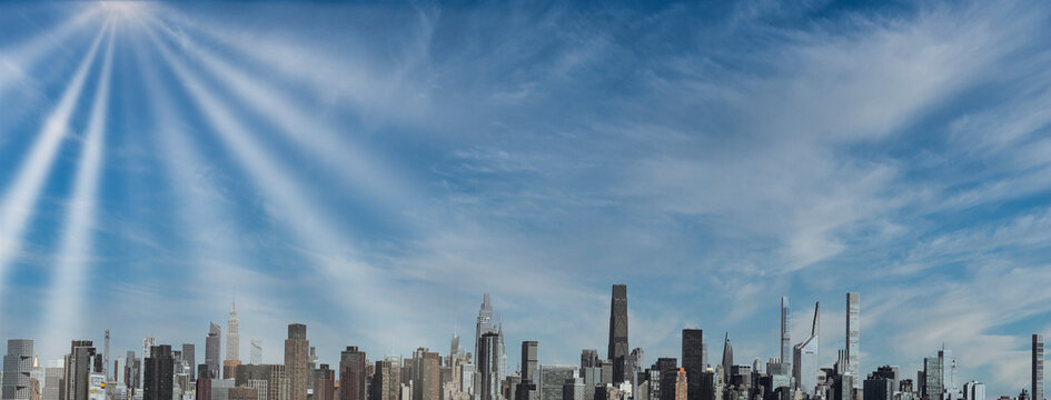 Panoramic View of Midtown Manhattan Skyline Under Dramatic Blue Sky