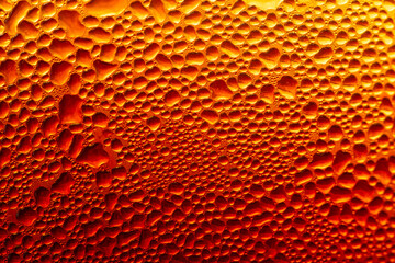 Golden Condensation Droplets on Cold Glass Surface Background,Macro,Close-up macro abstract background of water condensation and tiny water droplets covering a cold glass surface with vibrant warm gol © banjongseal324