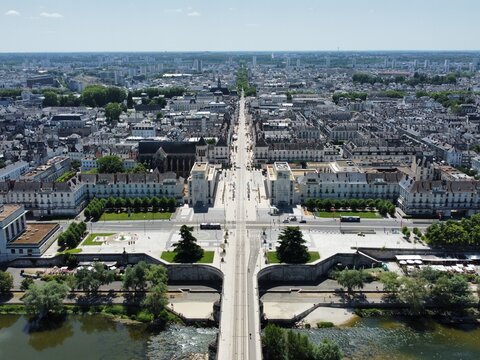 Aerial view of the historic city of Tours with its central boulevard, stone bridge over the Loire River, and dense urban architecture in Tours, Centre-Val de Loire, France.