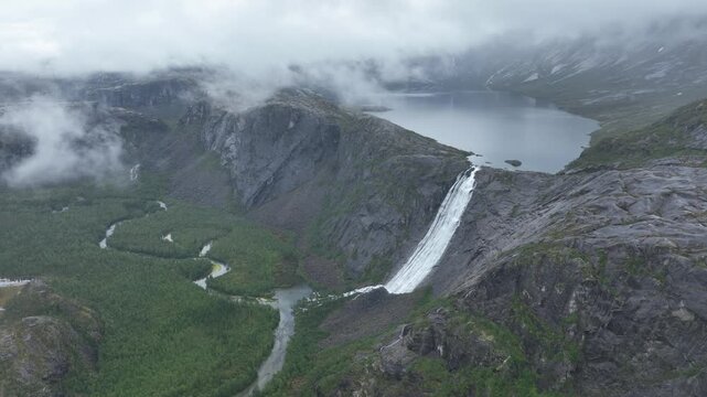Aerial view of massive waterfall, V&aelig;rivassfossen, and lake in Rago National Park, Norway