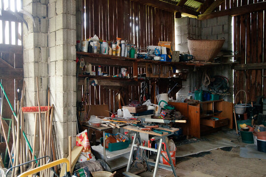 Cluttered interior of a rural wooden garage workshop
