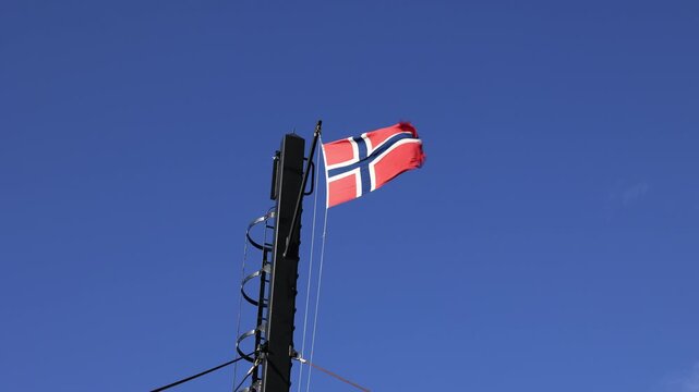 Norwegian flag flying on a mast head