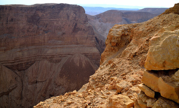 Deep canyon with layered rock strata seen from Masada in the Judean Desert, Israel