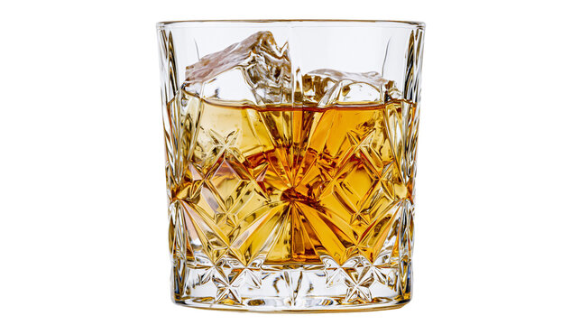 Amber whiskey with ice cubes in a crystal glass, isolated on transparent background