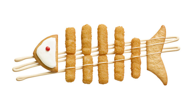 Crispy fish sticks arranged as a fish skeleton with a cookie head, isolated on transparent background