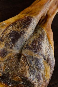Raw pork ham, cooked using special technology. Macro texture of dried ham meat: close-up of golden fat and dark meat fibers. Part of Spain's cultural heritage and gastronomic identity