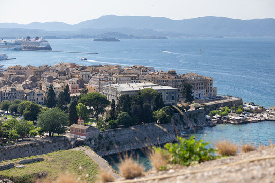 scenic aerial view of corfu old town, greece, featuring venetian architecture, blue ionian sea, and cruise ships