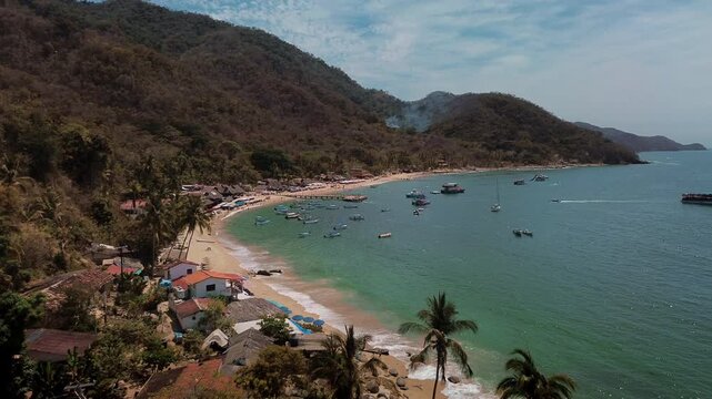Panoramic View of Animas Beach Pier Surrounded by Tourist Boats with Swimmers in Turquoise Waters