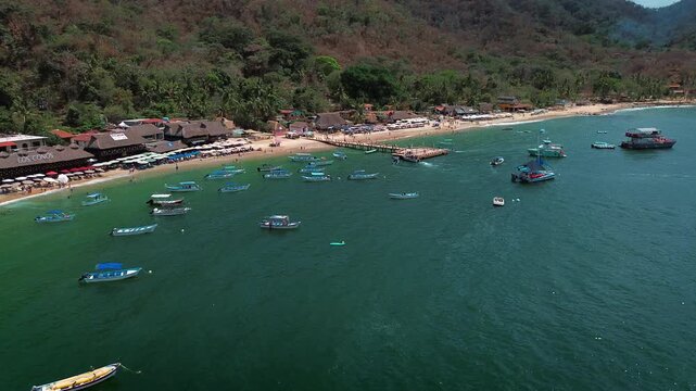 Panoramic View of Animas Beach Pier Surrounded by Tourist Boats with Swimmers in Turquoise Waters
