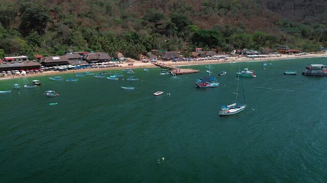 Panoramic View of Animas Beach Pier Surrounded by Tourist Boats with Swimmers in Turquoise Waters