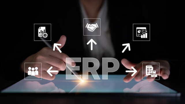 Business professional interacting with digital technology, showcasing ERP system with icons representing data management, collaboration, and analytics in a dark environment. Glyphic.