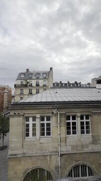 Elevated View of Classic Parisian Rooftops and Red Brick Architecture