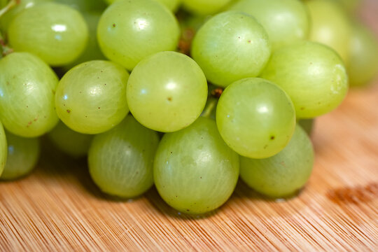 Close-up of grapes on a cutting board in the kitchen. Sweet food, healthy lifestyle, subtropical fruit, organic, fructose, raw food.