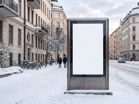 Blank vertical billboard mockup standing on a snowy city street in winter.