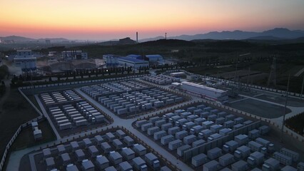Fototapeta premium Large-scale energy storage power station at sunset with battery arrays and industrial facilities
