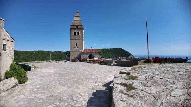 Lubenice on Cres Island, Croatia. Medieval stone houses and parish church overlooking. A village known as starting point of trek to Sveti Ivan Beach or Lubenice Beach, the most famous beach on Cres.