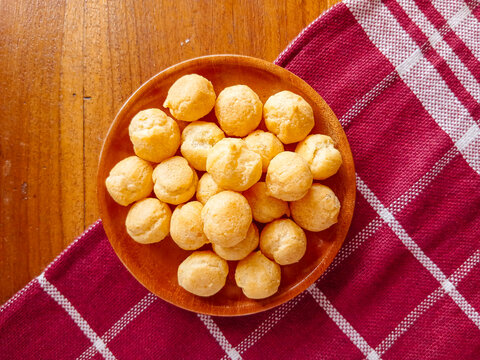 Dry soes cake or Kue soes kering, delicious cheese soes cake in a wooden plate