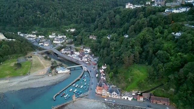 Aerial view of the harbor and village nestled between lush green hills and the coastline in Lynmouth, England, United Kingdom.