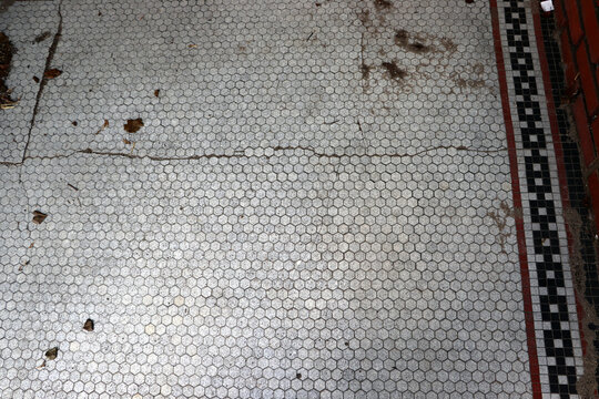 Vintage hexagonal mosaic tile floor pattern in historic doorway