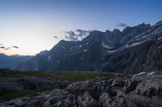 Hiker enjoying the view at dawn from her bivouac in Cirque de Gavarnie.