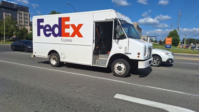FedEx delivery truck driving on a city street