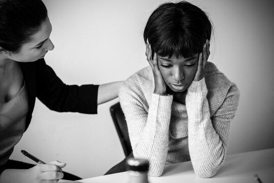 Caucasian woman therapist providing psychological help to female african american patient, comforting her - Treatment of emotional and mood disorders - Black and white editing