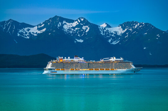 Haines, Alaska, July 17, 2026: Side View of Illuminated Anthem of the Seas Cruise Ship Sailing at Night Against Mountain Landscape
