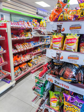 San luis potosi, mexico, 04 15 2026, convenience store shelves displaying various packaged chips and snacks inside a market
