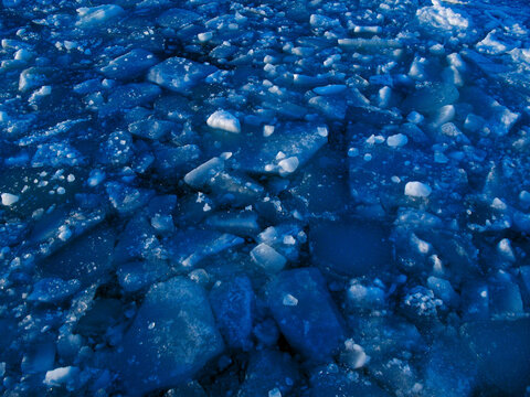 Broken Blue ice on Baltic sea background