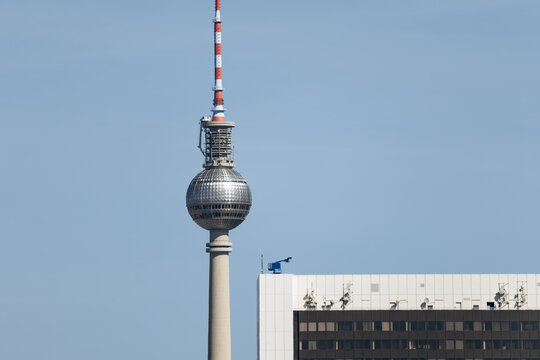 Berlin, Germany - April 23, 2026: The Fernsehturm television tower rises above central Berlin with the Park Inn by Radisson hotel and the Berlin Cathedral seen from the Reichstag rooftop.