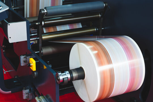 Large industrial offset printing machine prints image on packaging film. tech industrial technology background