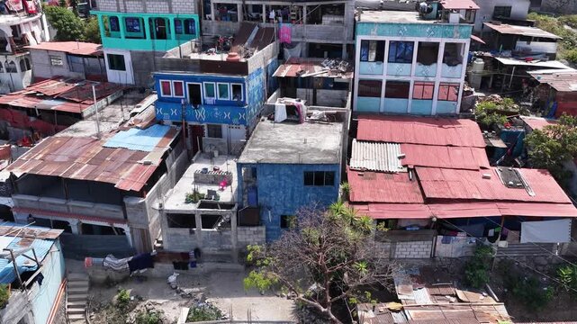 Aerial view of colorful residential rooftops and concrete structures in the town of Santiago Atitlan, Solola Department, Guatemala.
