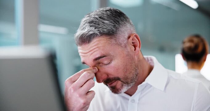 Computer, tired and man with stress in office, eye strain or burnout for tax filing deadline. Tech, accountant and mature person with fatigue for fraud investigation, cashflow problem or audit error