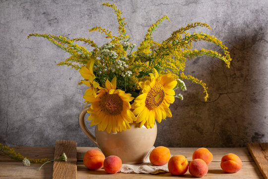 Rustic Sunflower Bouquet with Goldenrod, Yarrow and Apricots on Wooden Table