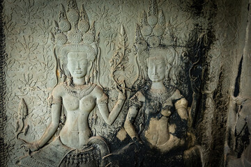 Fototapeta premium Ancient stone carving of a female Apsara dancer inside Angkor Wat temple in Siem Reap, Cambodia