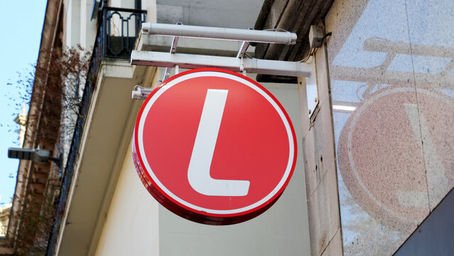 Leicester, England, UK - 19 July 2026: Ladbrokes. Red L letter sign on street wall, betting shop exterior, gambling retail store