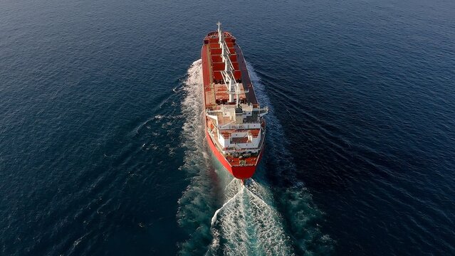 Great cargo ship sailing fast in open waters of the Mediterranean Sea close to the Spanish coast.