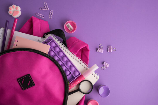 Back to school supplies, backpack, notebooks, pens, pop it toy