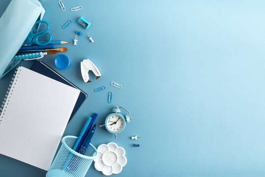School supplies arranged on a blue background