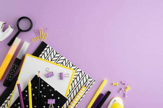 School supplies organized on purple background