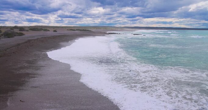 4K video; Surf on a pebble beach, Punta Tomba at the east coast of Argentina