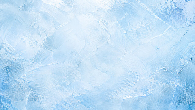 Blue ice texture background. Frozen water surface with cracks and crystalline patterns.