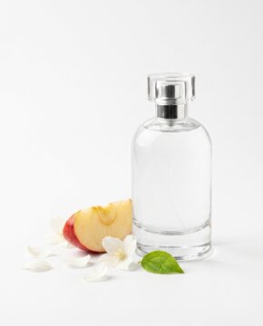 Perfume Bottle with Peach Slice and White Flowers