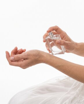 Woman Applying Perfume on Wrist in Bridal Dress