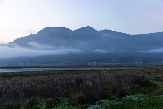 delicate fog hovering below Klein Mountains and lagoon, Stanford, South Africa