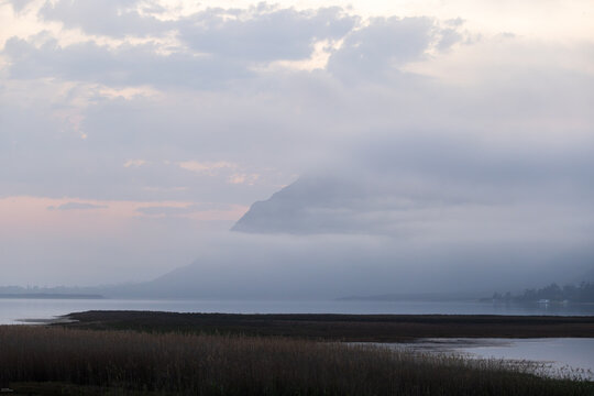 delicate fog hovering below Klein Mountains and lagoon, Stanford, South Africa